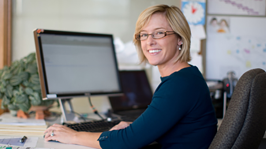 Smiling woman at work in her office.