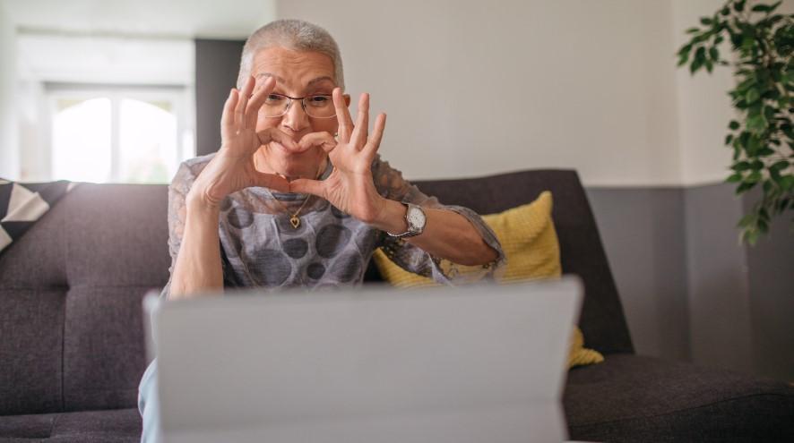 Senior woman heart symbol video call