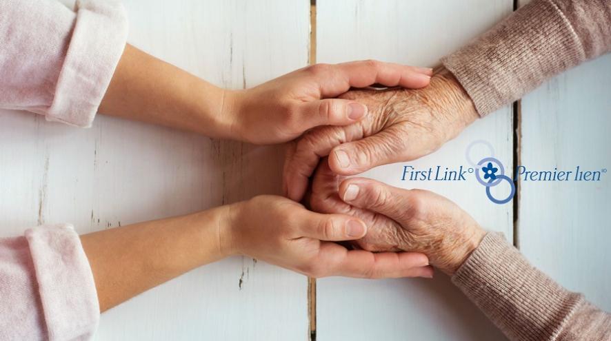 A set of hands clasping an older set of hands