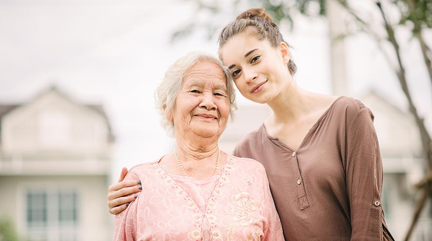 Granddaughter hugging her grandmother.