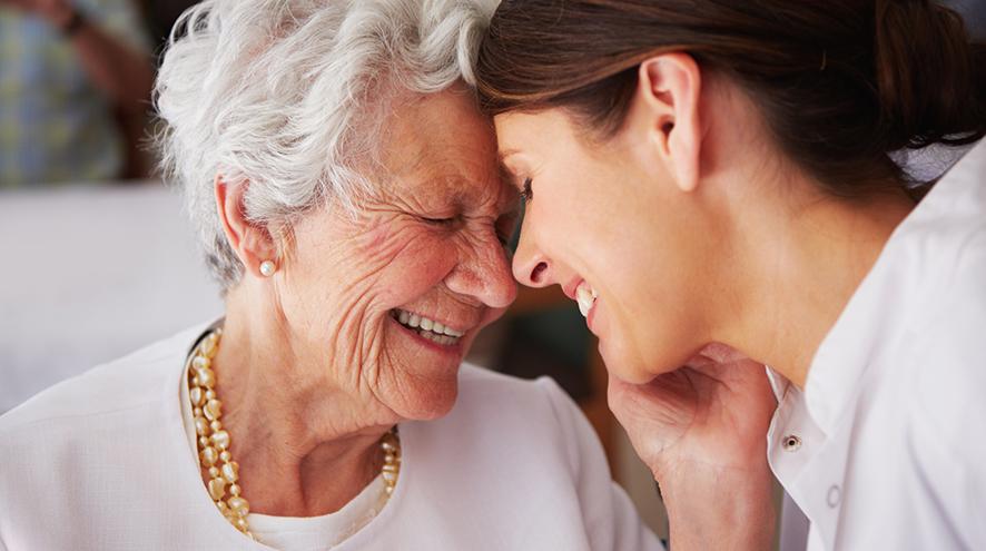 Two women smiling at each other.