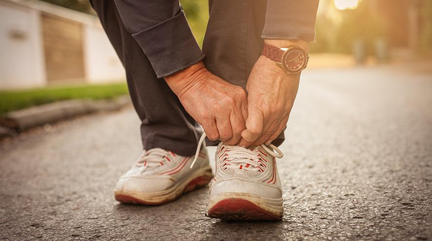 Person tying their shoelaces.