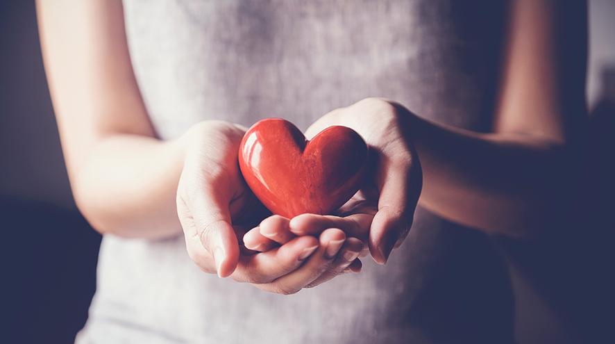 Woman holding heart figurine.