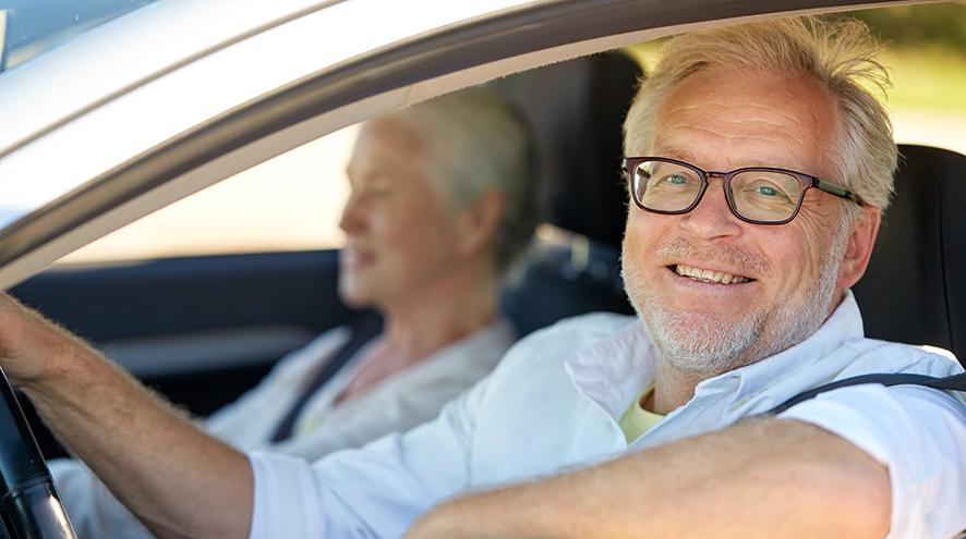 Senior man at the wheel of his car.